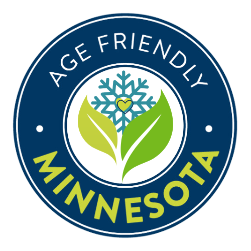 A blue circle with the icon of a hand with a green heart in the center. The words Age-Friendly Minnesota encircle the icon