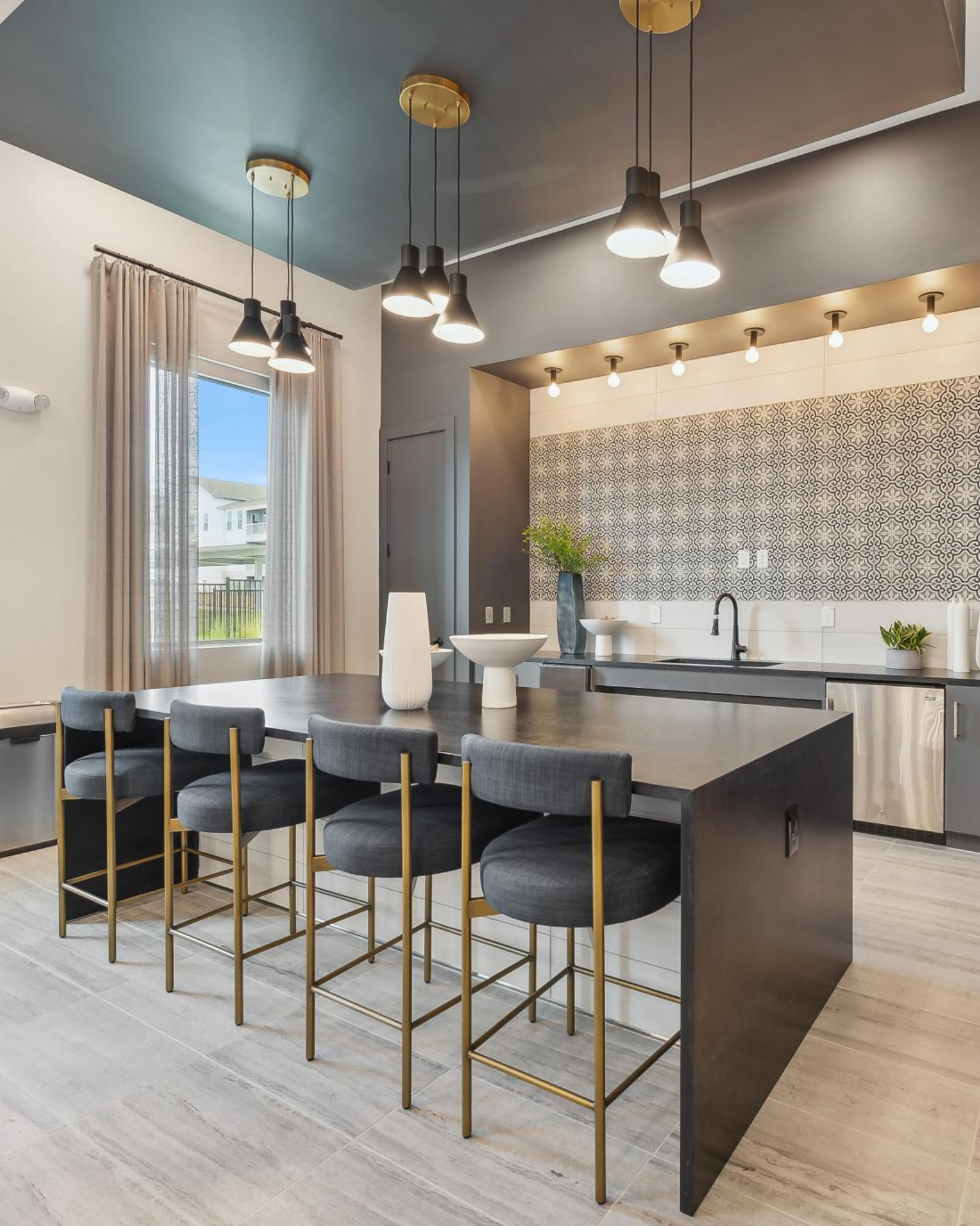 A kitchen with a large island and stools