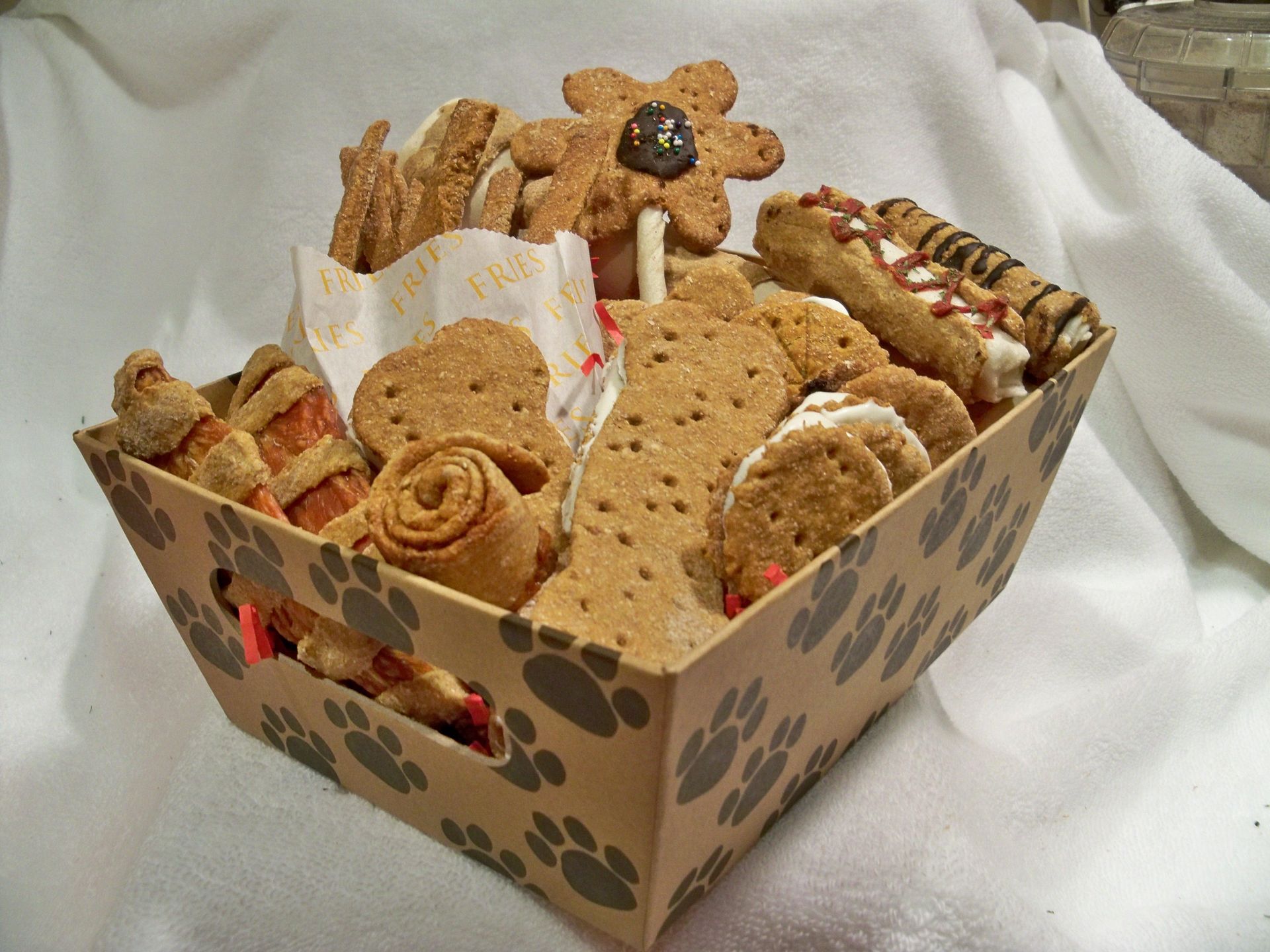 A cardboard box filled with a variety of dog treats