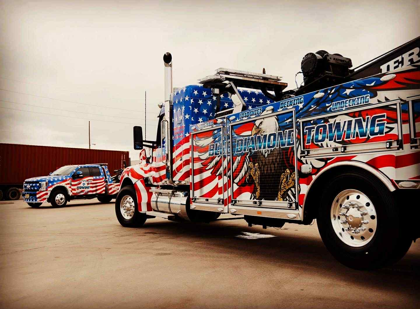 Tow truck and SUV with American flag-themed paint job;