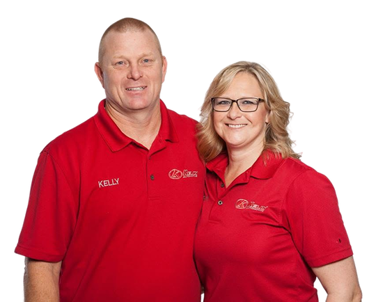 Two smiling people in red polo shirts posing against a white background | Kelly Automotive