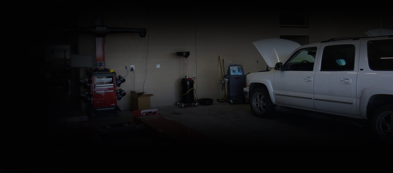 Dim garage with a white car | Kelly Automotive.