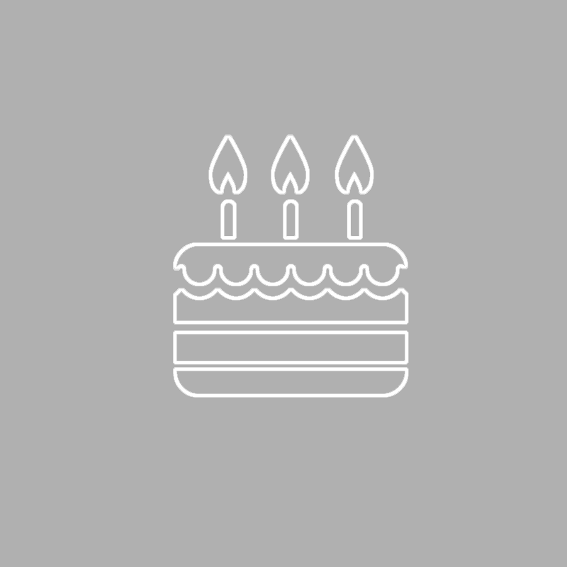 A line drawing of a birthday cake with three candles on a gray background.