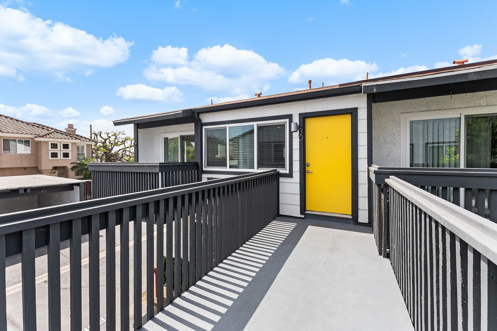Yellow front door with railing
