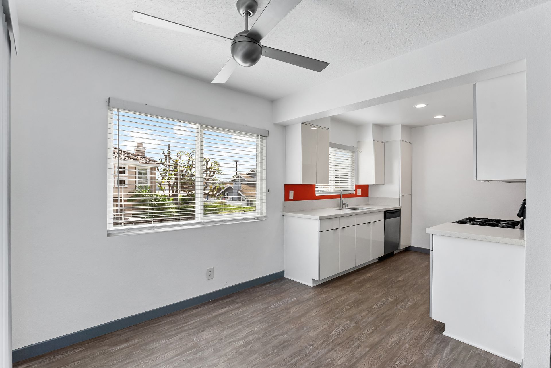 Sliding Photo Gallery Displaying Apartment Features- Kitchen with orange wall and ceiling fan