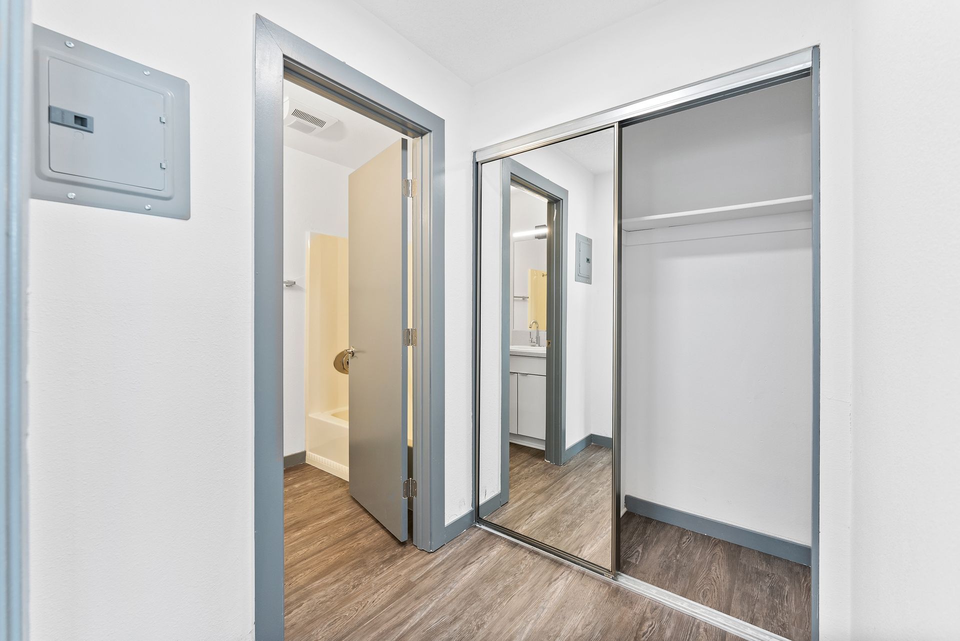 Sliding Photo Gallery Displaying Apartment Features- Hallway with open closet door and open door to bathroom