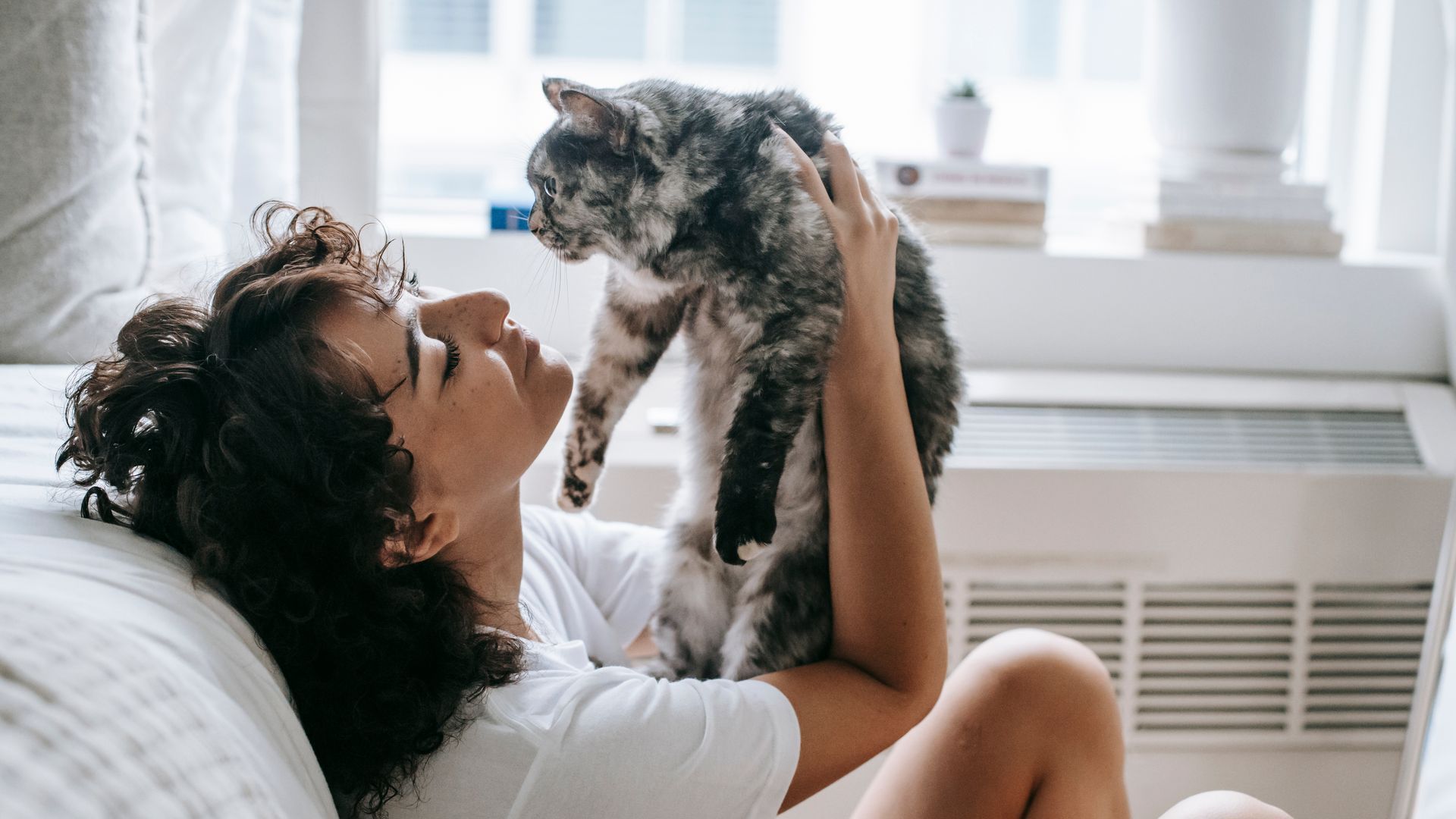 Woman playing with her cat