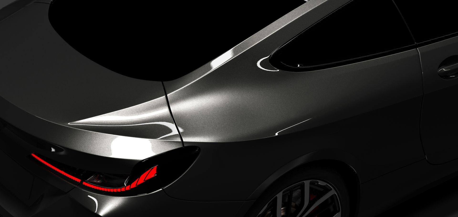 Close-up of a dark gray car, showing rear quarter panel and taillight.