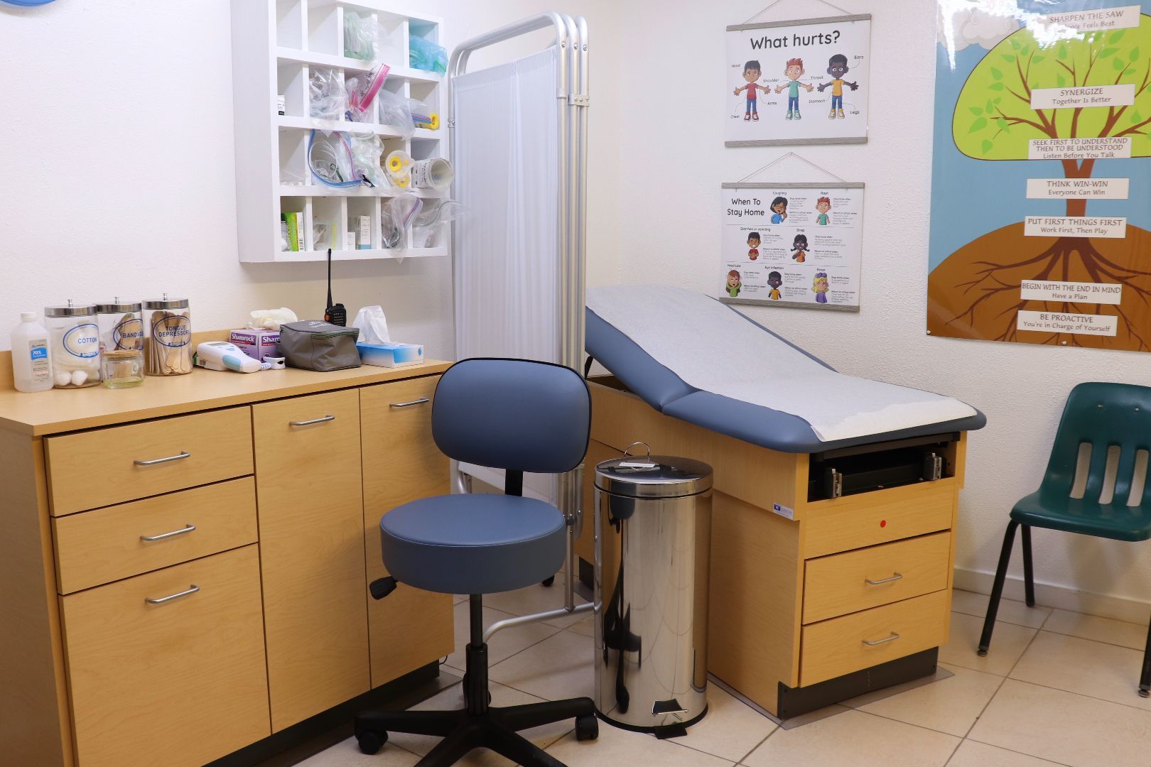 A doctor 's office with a table and chairs
