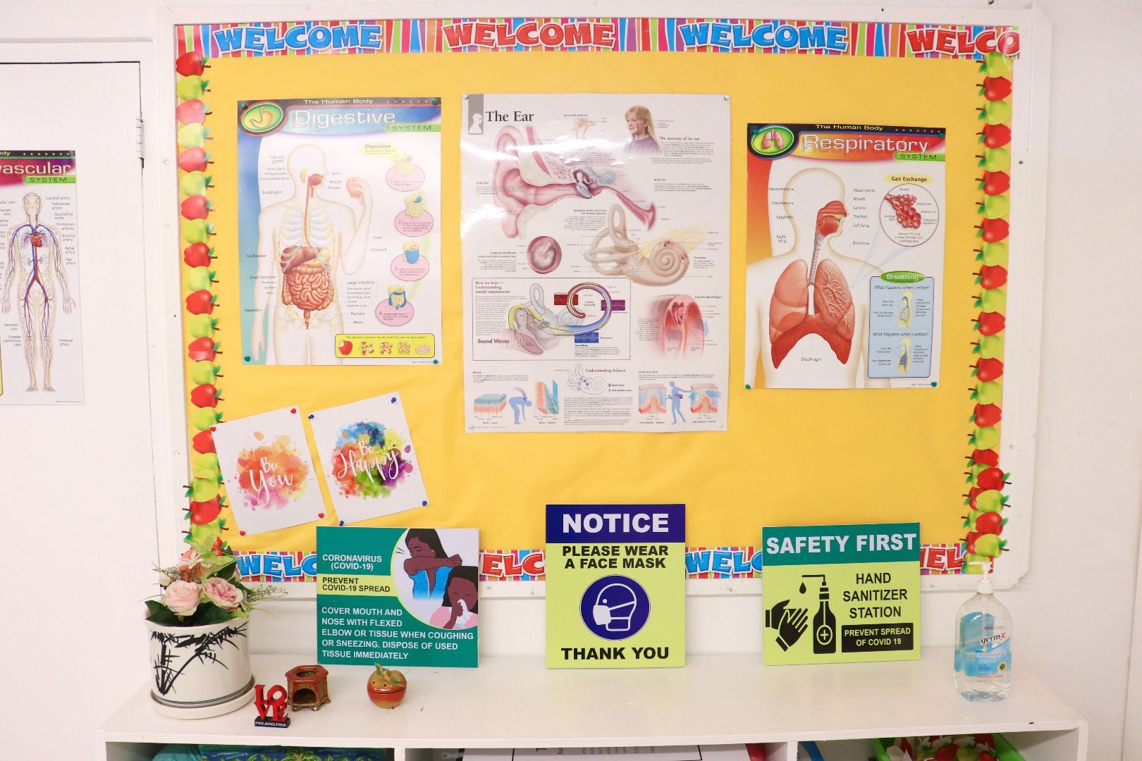 A yellow bulletin board with a notice sign on it