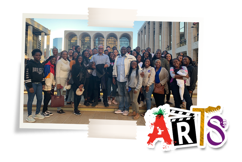 A group of people standing in front of a building with the word arts on the bottom