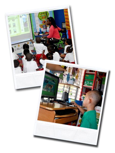 A group of children are sitting in a classroom watching a computer screen