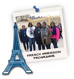 A group of people are standing in front of the eiffel tower.