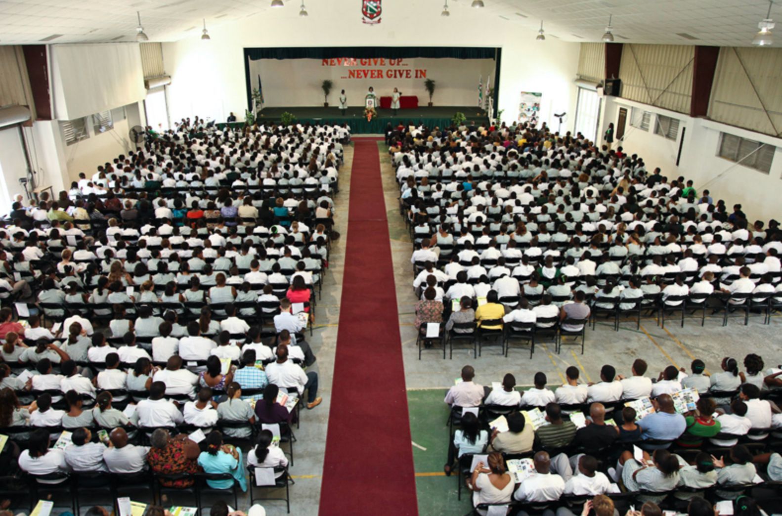 A large auditorium with a red carpet leading to the stage