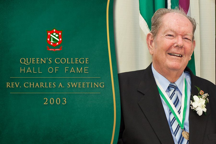 A man is standing in front of a banner that says queens college hall of fame