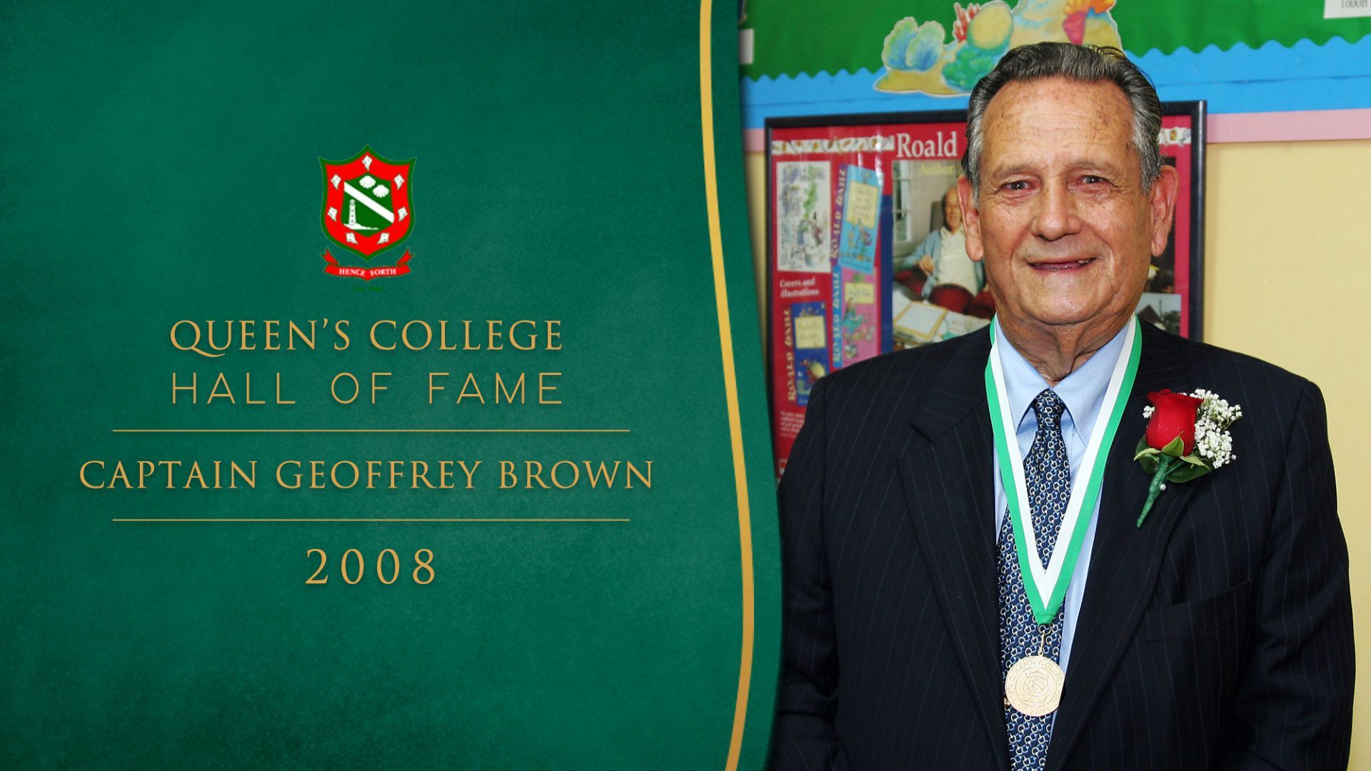 A man in a suit is standing in front of a banner that says captain geoffrey brown