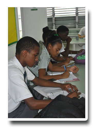 A group of students are sitting at desks in a classroom