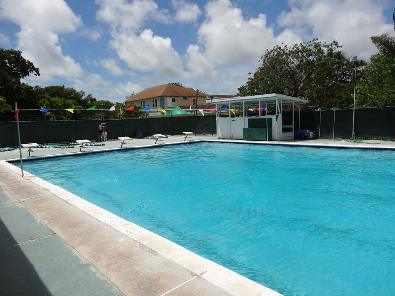 A large swimming pool with a building in the background