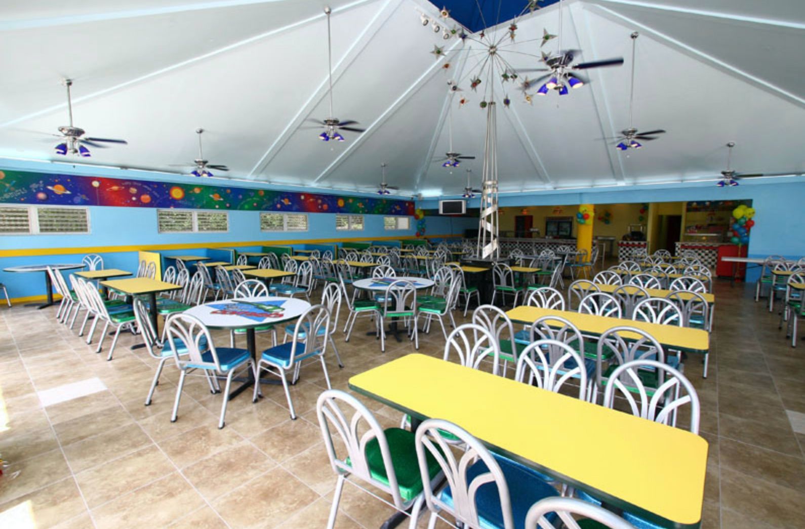 A large dining room with many tables and chairs