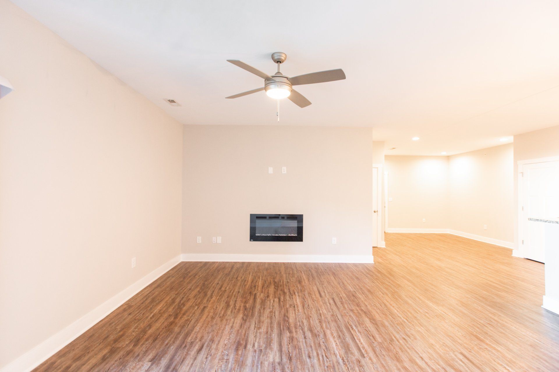 Living room with ceiling fan and fire place.