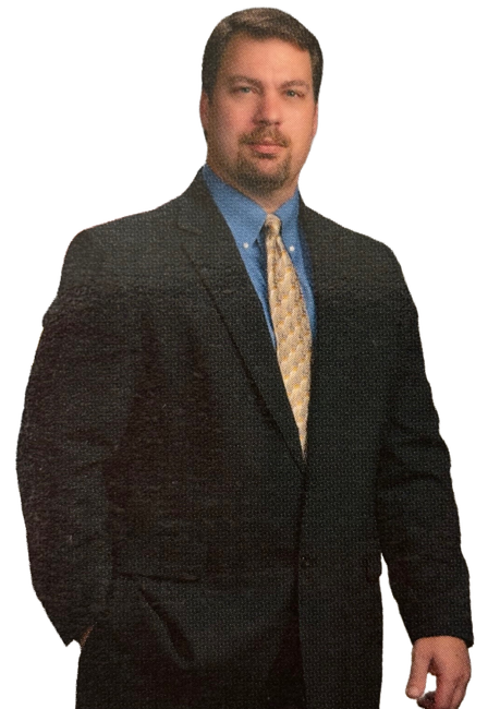 A man in a suit and tie with his hands in his pockets