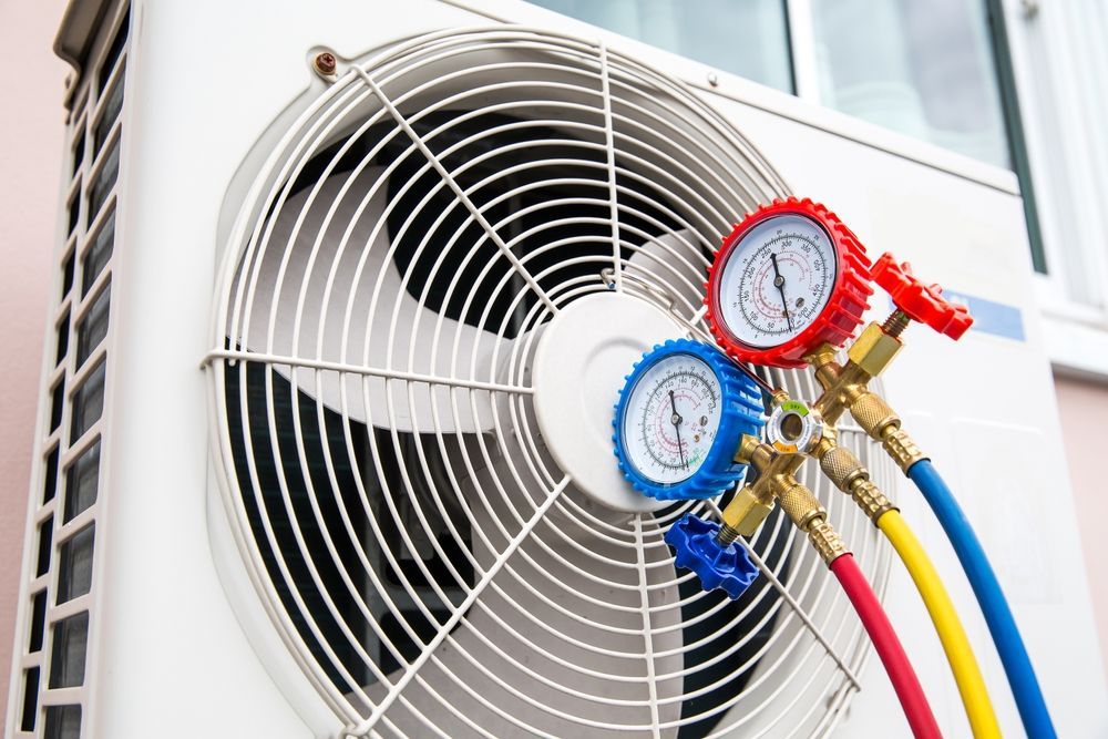 A close up of a fan with two gauges attached to it.