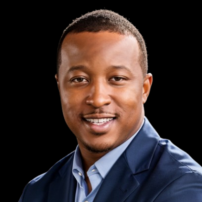 Studio headshot of a smiling man in a navy blazer against a black background