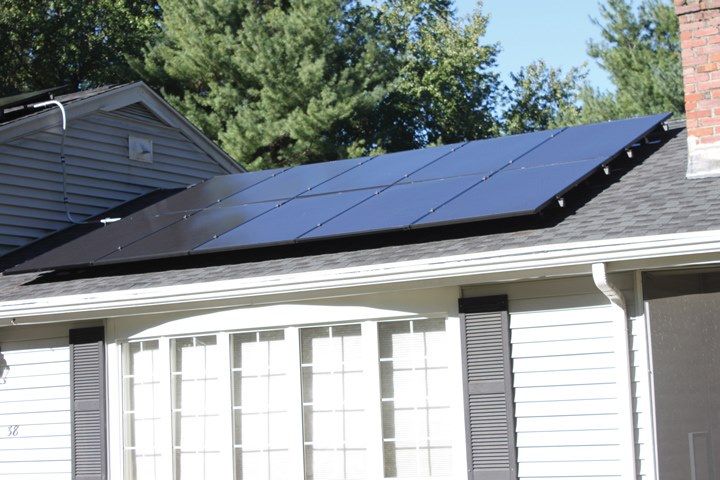 A house with a lot of solar panels on the roof