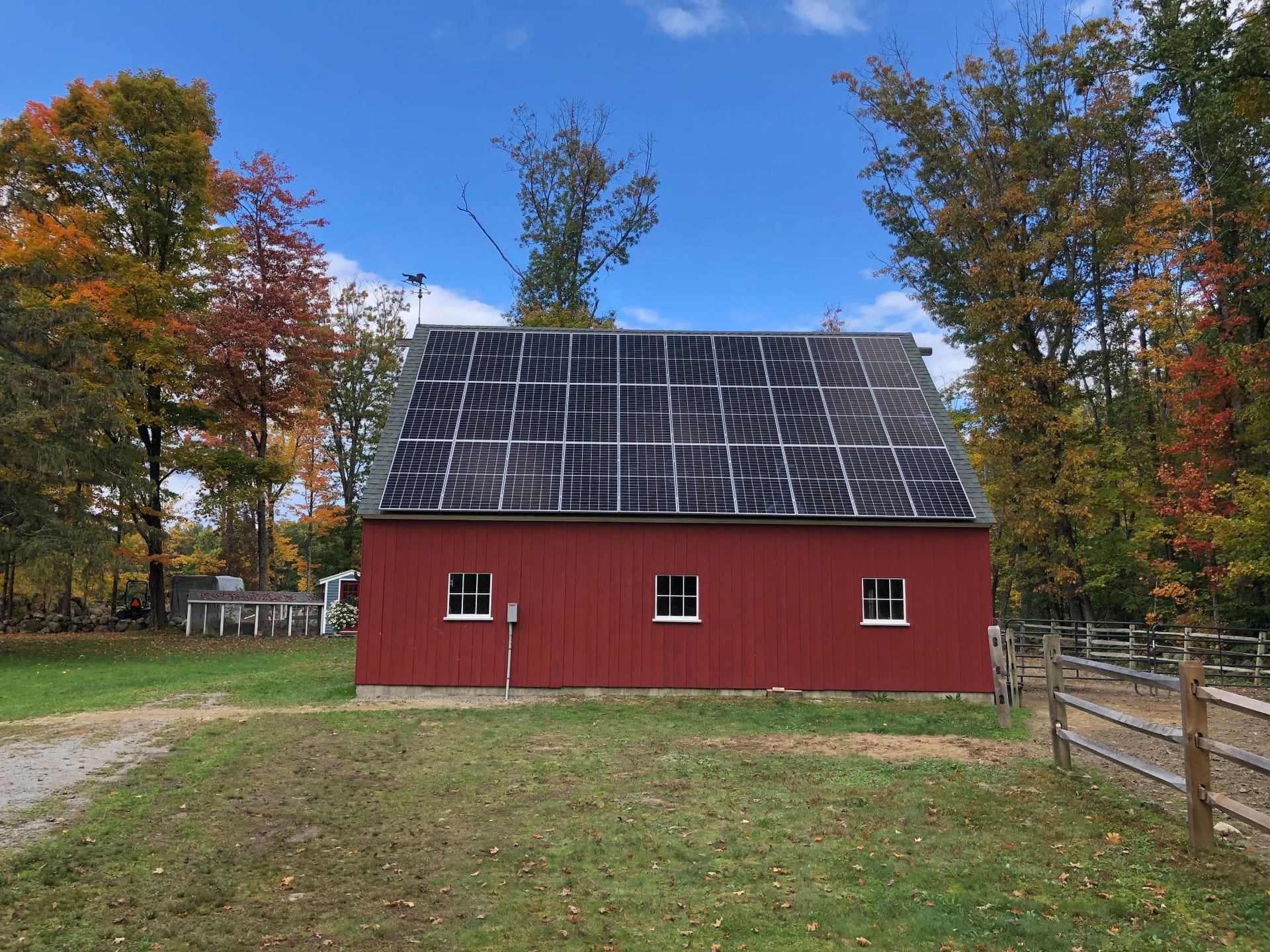A red barn with solar panels on the roof