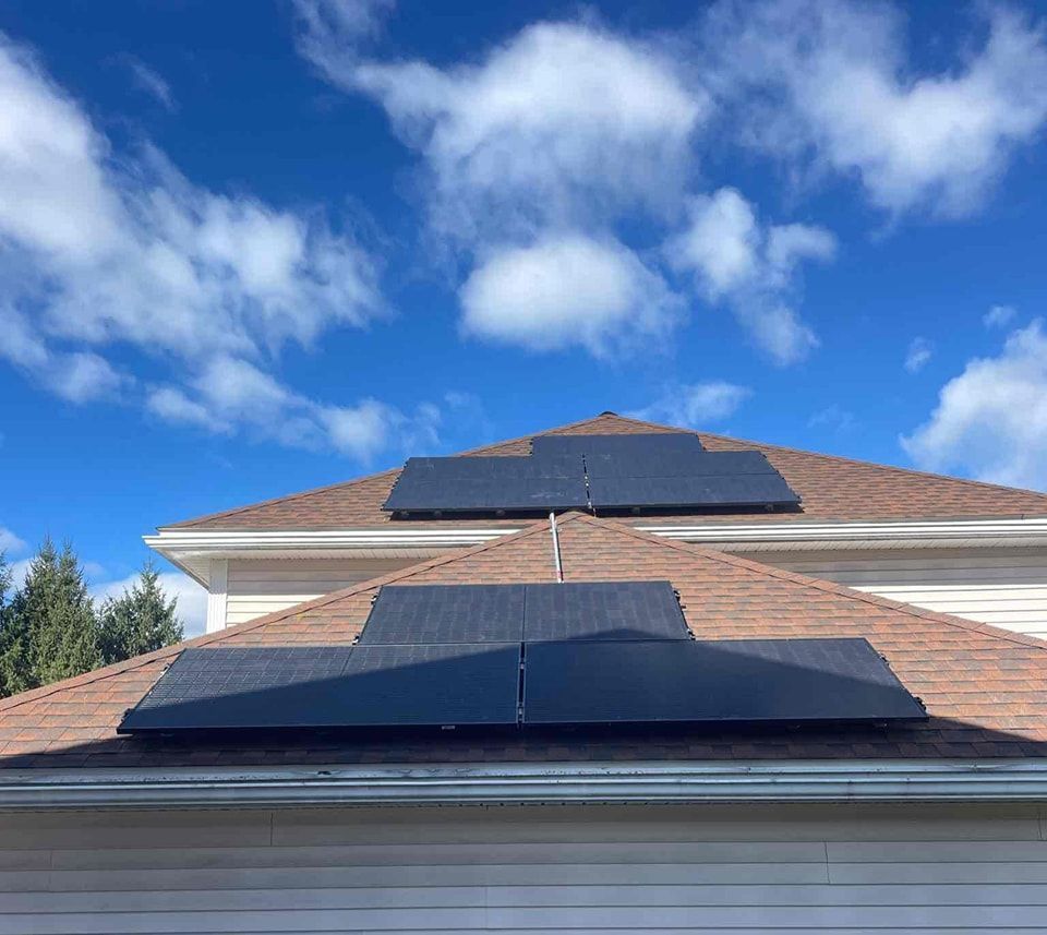 There are two solar panels on the roof of a house.