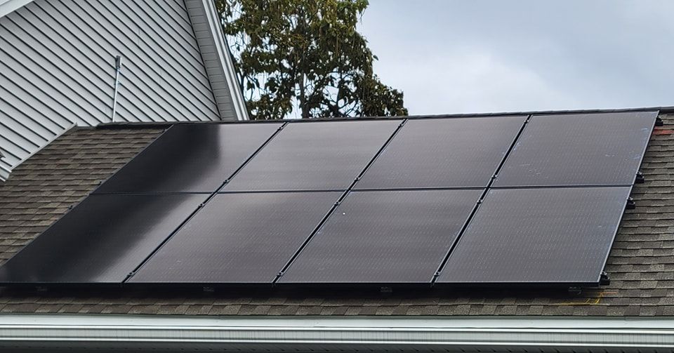 A row of solar panels on the roof of a house