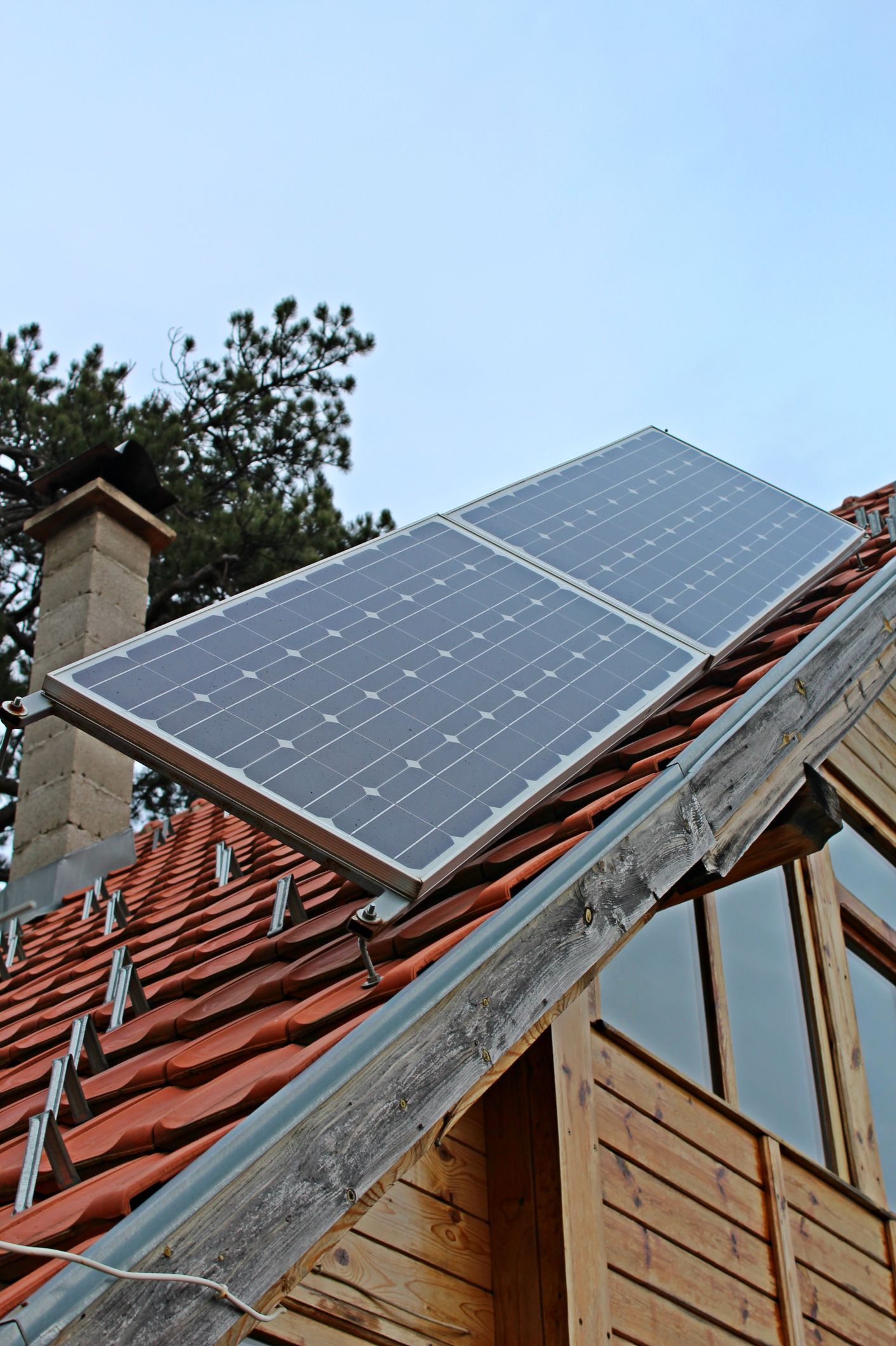 A wooden house with solar panels on the roof
