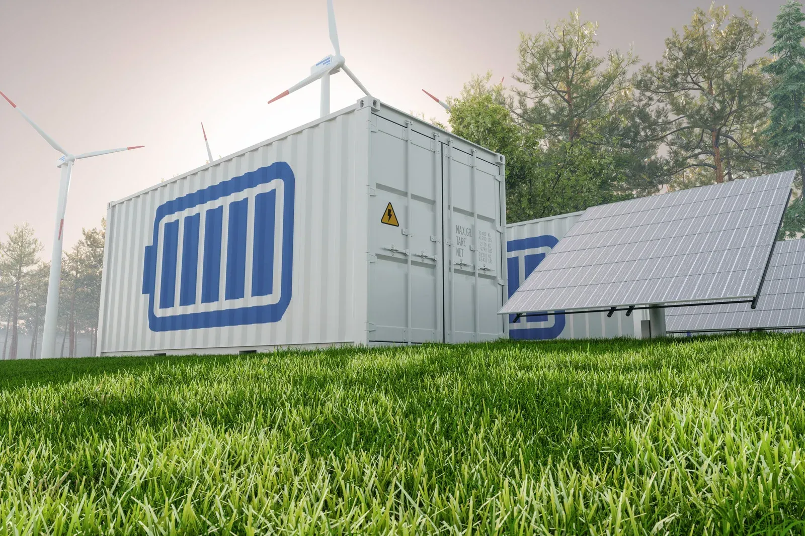 A container with a battery on it is sitting on top of a lush green field.