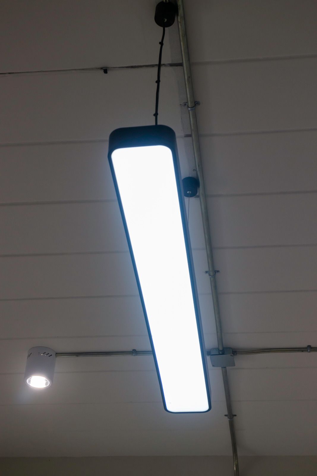 A light fixture is hanging from the ceiling in a room.