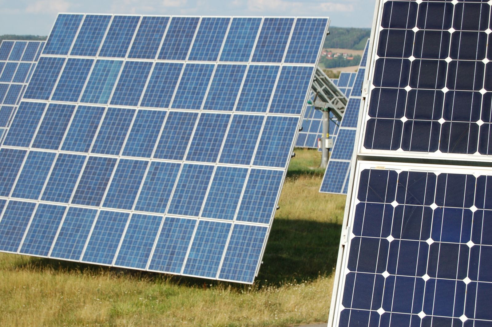 A row of solar panels are sitting in a field