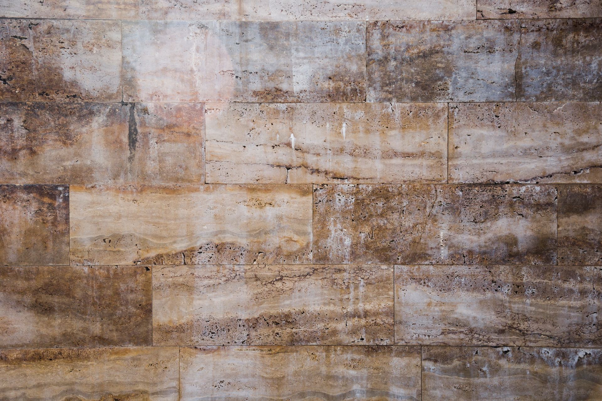 A close up of a brick wall with holes in it