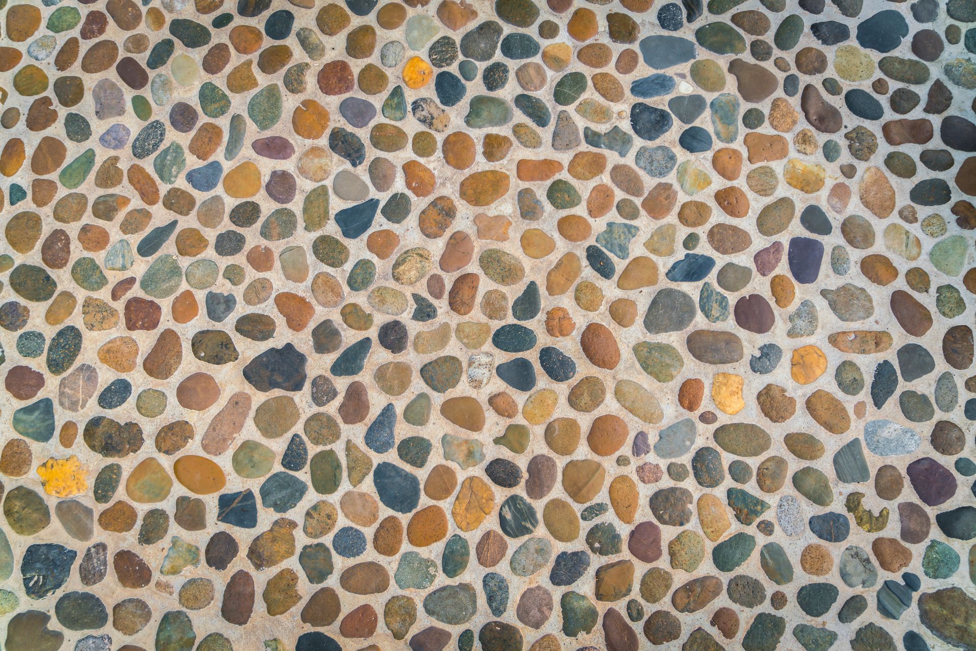 A close up of a stone floor with a lot of different colored rocks.