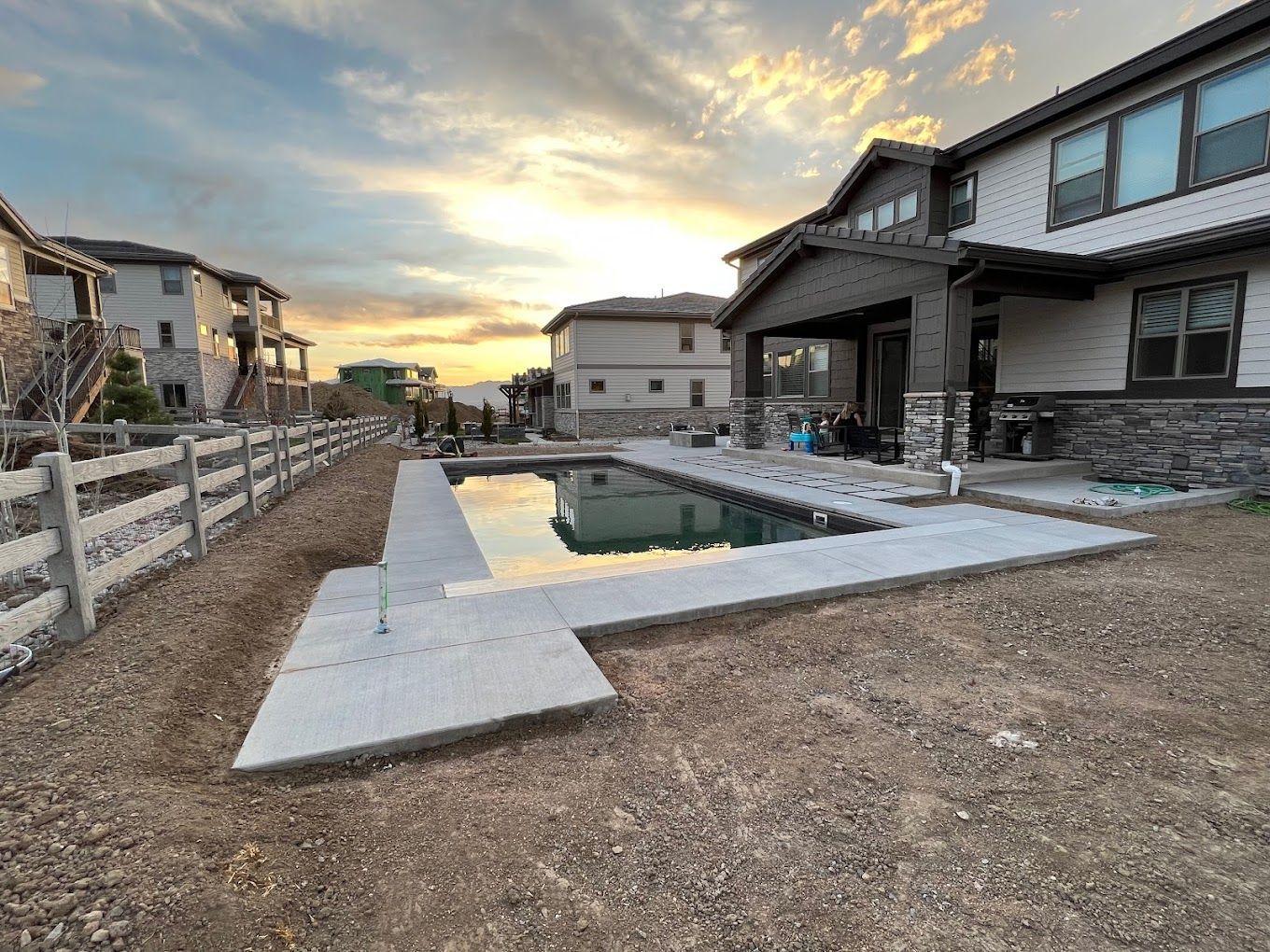 A large house with a swimming pool in front of it.