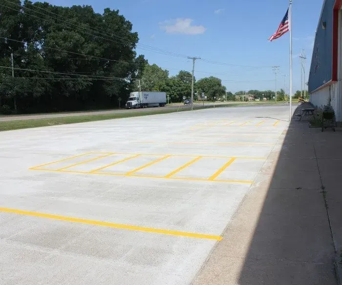A truck is parked on the side of the road in a parking lot