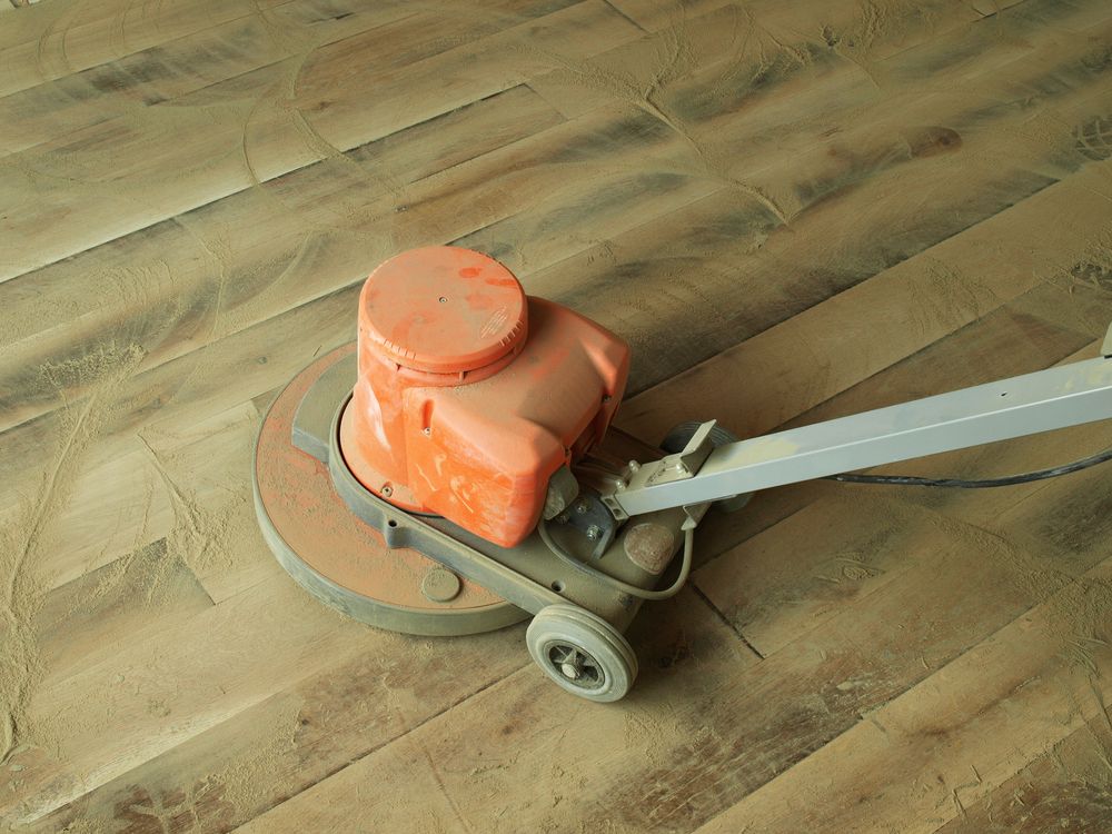 A Machine Is Being Used To Polish A Wooden Floor — Coastline Floor Sanding in Wyong, NSW