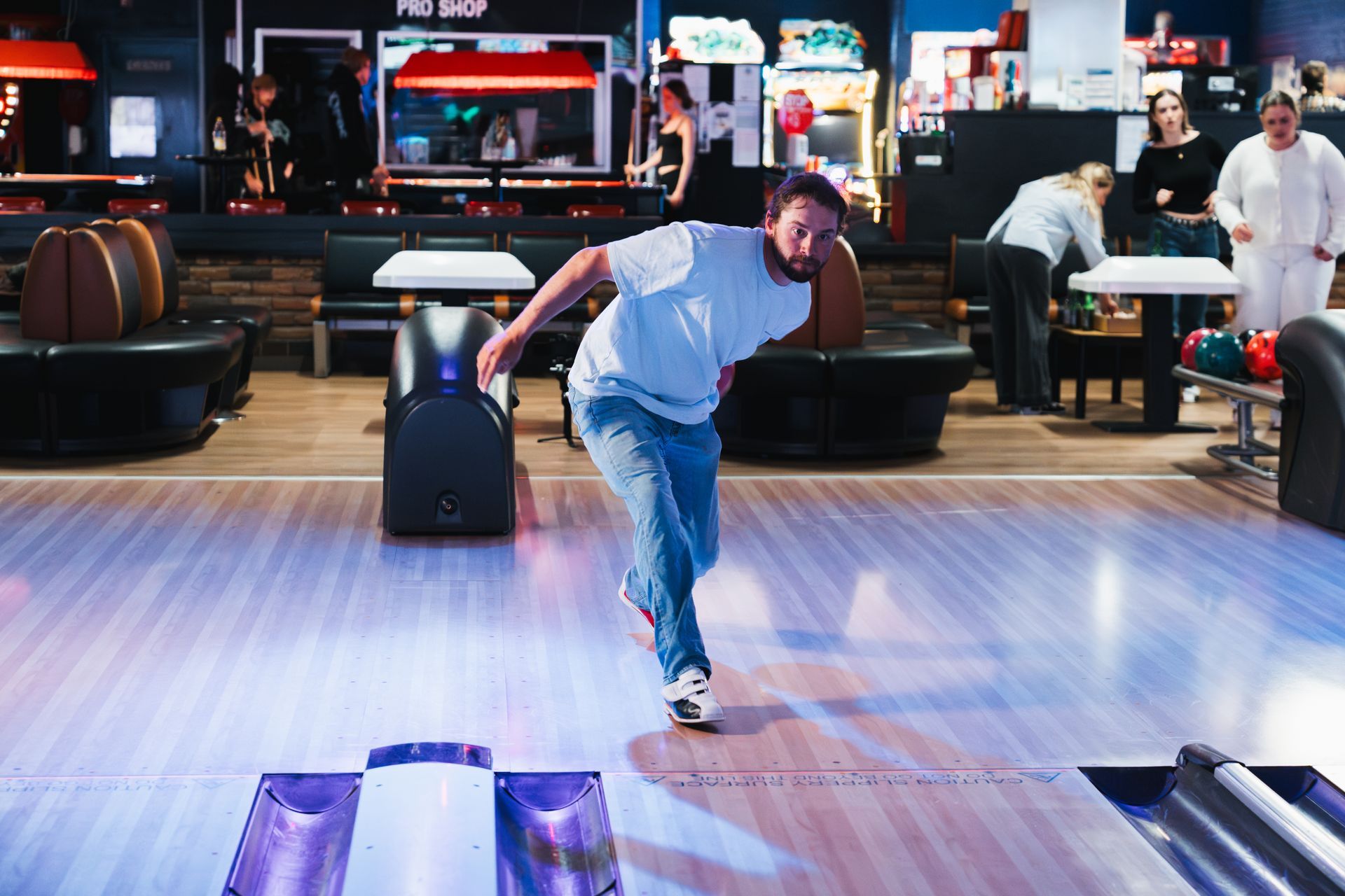 Person Bowling in a Neon-lit Bowling Alley While Others Watch Nearby — Orange Tenpin Bowl in Orange, NSW