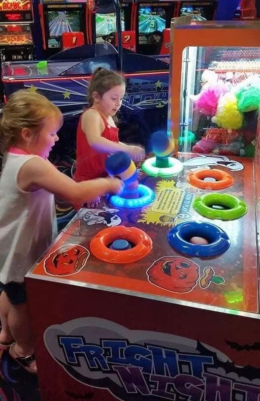 Two Children at an Arcade Game, Using Glowing Mallets to Hit Lit Targets — Orange Tenpin Bowl in Orange, NSW