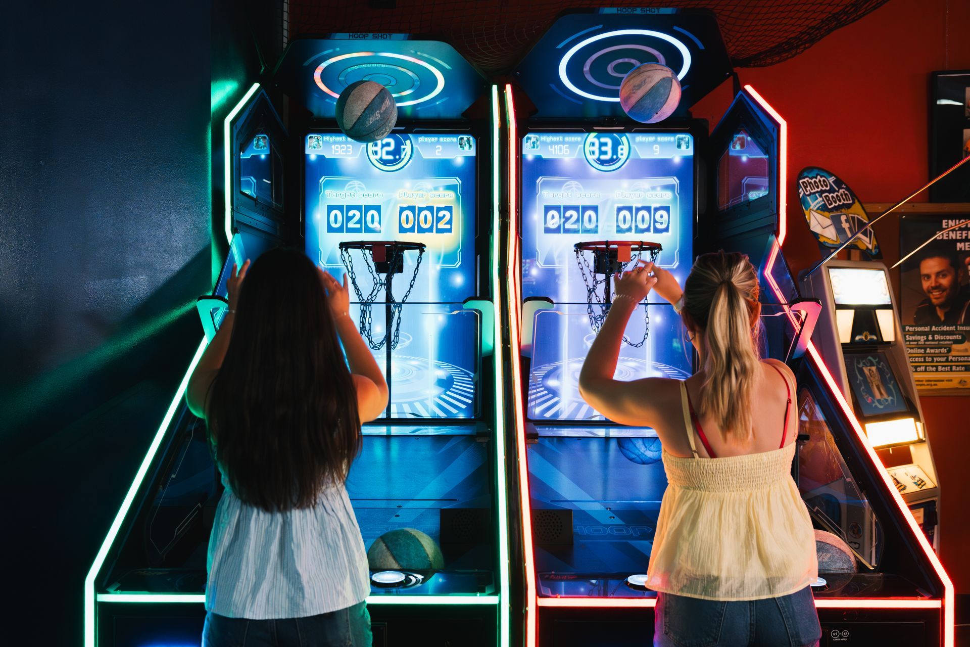 Two People Playing Arcade Basketball Games With Neon Lights in a Dark Arcade Room — Orange Tenpin Bowl in Orange, NSW