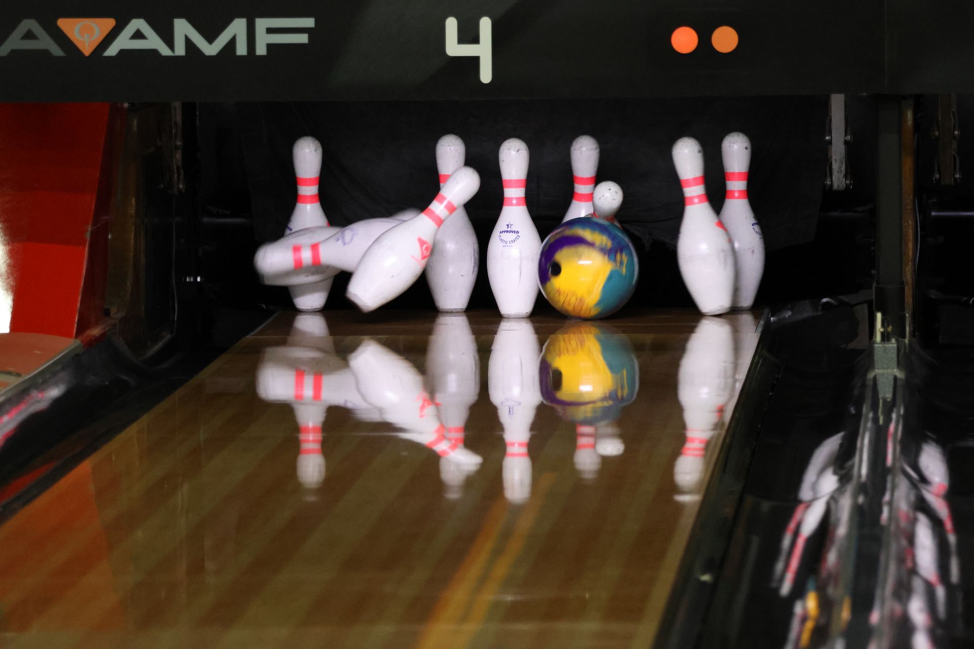 Bowling Lane With Several White Pins Near the End and a Blue-yellow Bowling Ball — Orange Tenpin Bowl in Orange, NSW