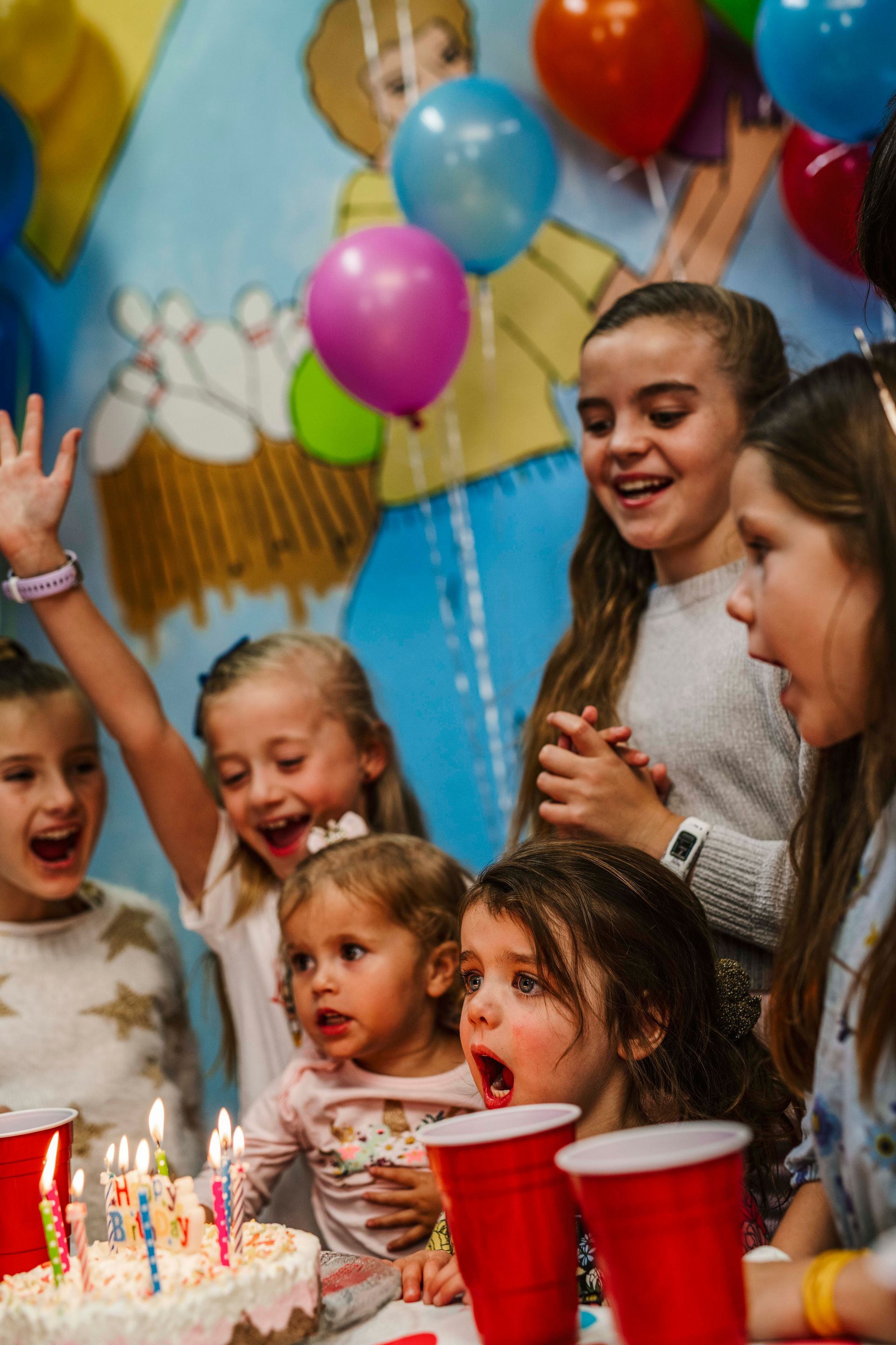 Children Celebrating With a Birthday Cake, Candles, Balloons, and Red Cups at a Party — Orange Tenpin Bowl in Orange, NSW