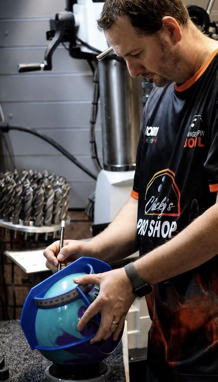 A Mechanic Paints a Blue Helmet in a Workshop — Orange Tenpin Bowl in Orange, NSW