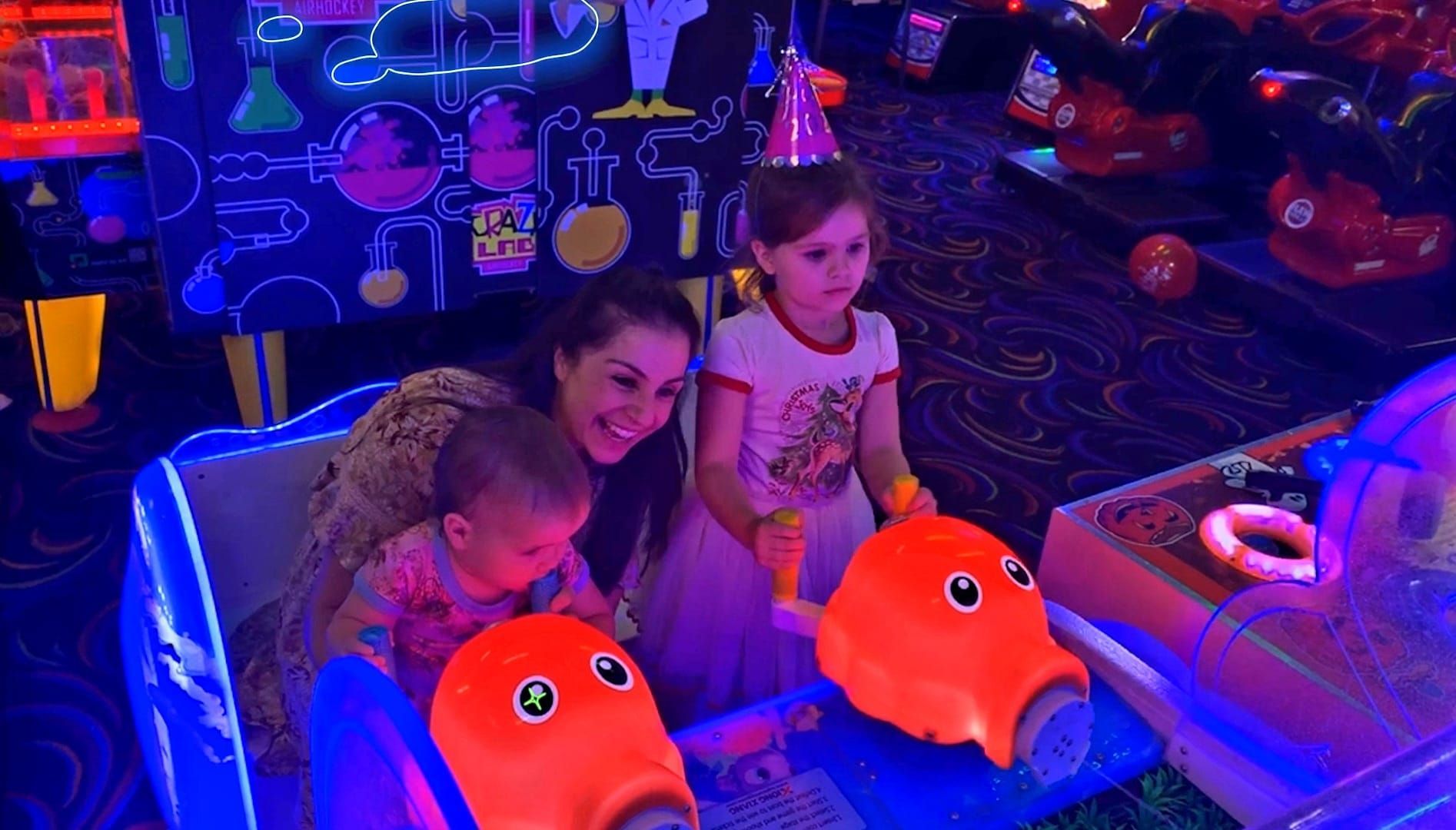 Family Riding a Glowing Arcade Game in a Neon-lit Play Area — Orange Tenpin Bowl in Orange, NSW