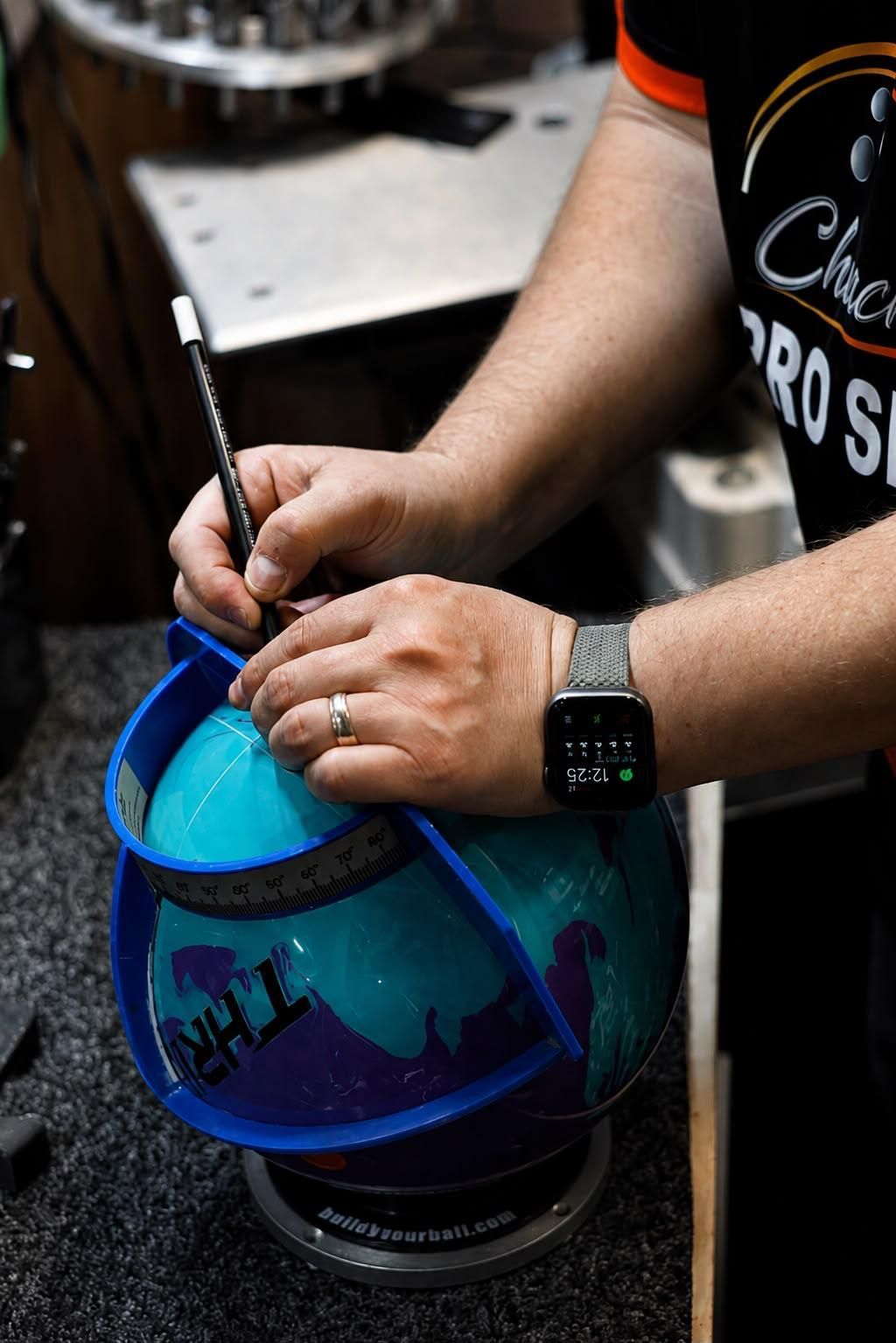 Person Painting a Blue Helmet With a Brush, Adding Dark Blue Details — Orange Tenpin Bowl in Orange, NSW