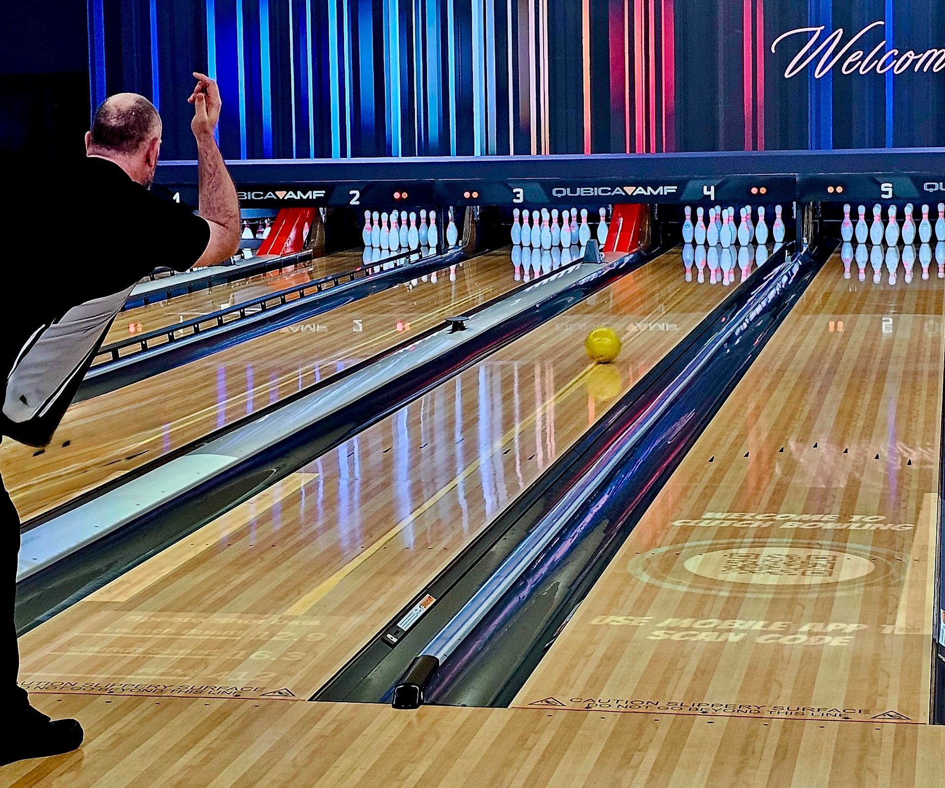 Bowling Alley With a Person Releasing a Ball Down the Lane Toward the Pins — Orange Tenpin Bowl in Orange, NSW