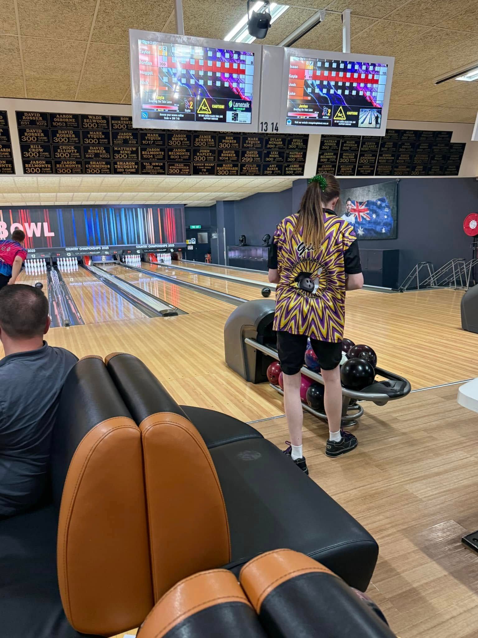 Bowling Alley With Two Overhead Score Screens and Bowlers on a Lane — Orange Tenpin Bowl in Orange, NSW